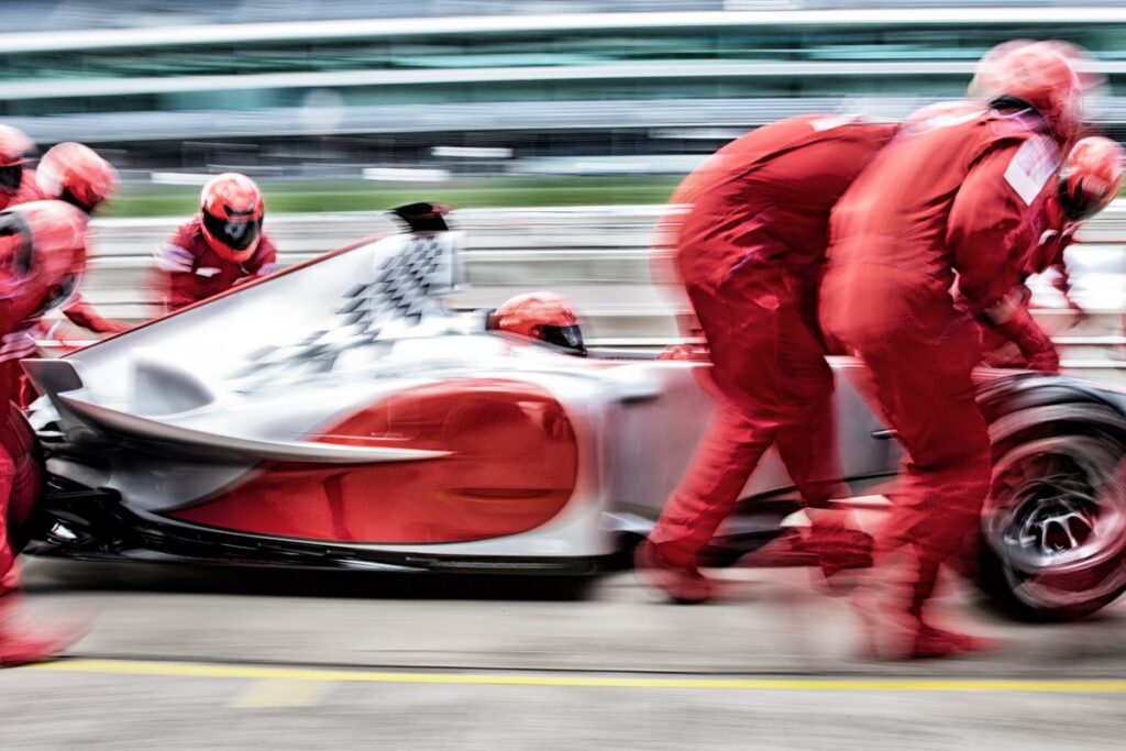 Pit crew working together on a race car